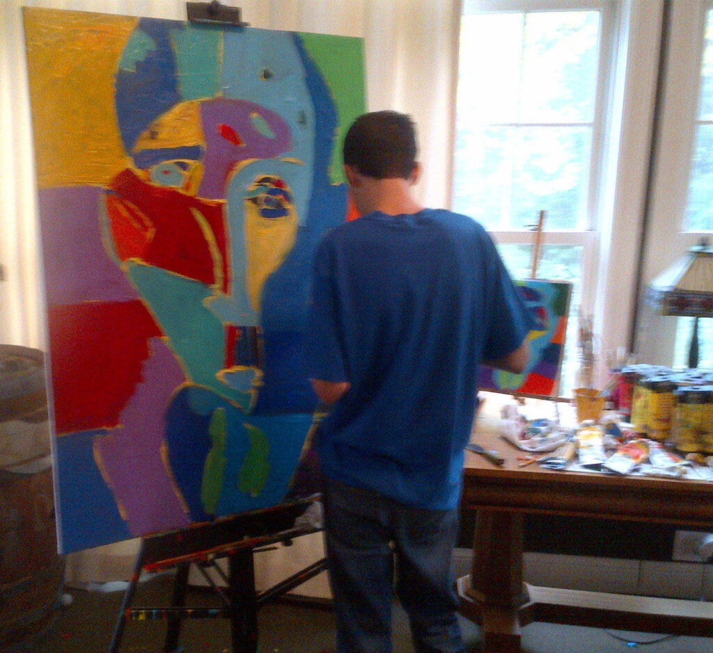 Artist Jimmy Reagan working on his painting "Man of the World"