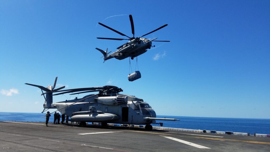 CH-53E delivering a AV-8B engine to a ship deck
