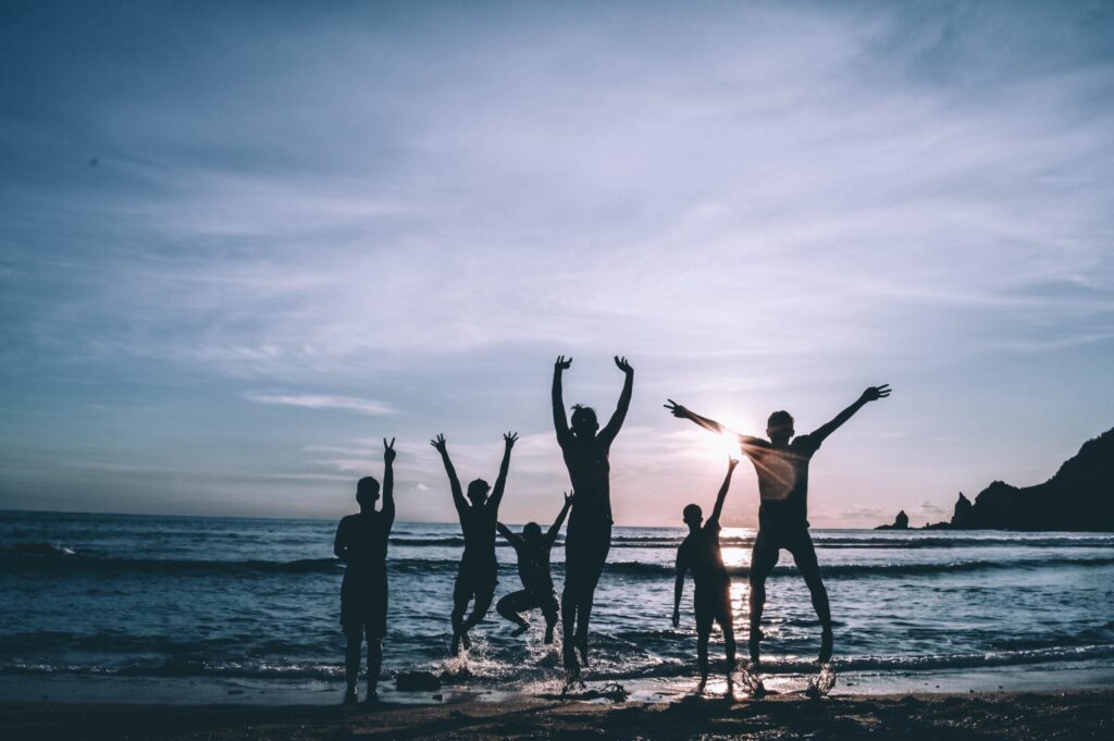 A group of people celebrating on the beach