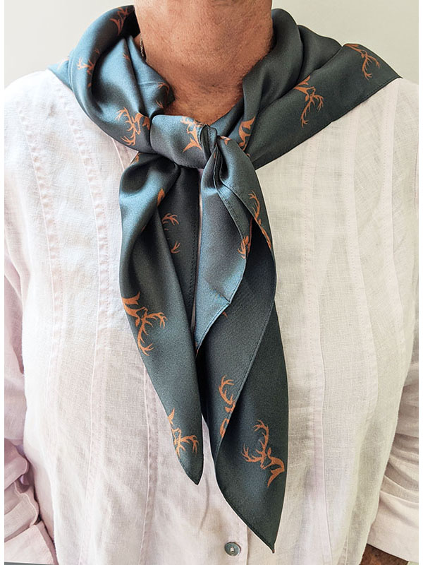 person wearing a custom gray square scarf with deer pattern