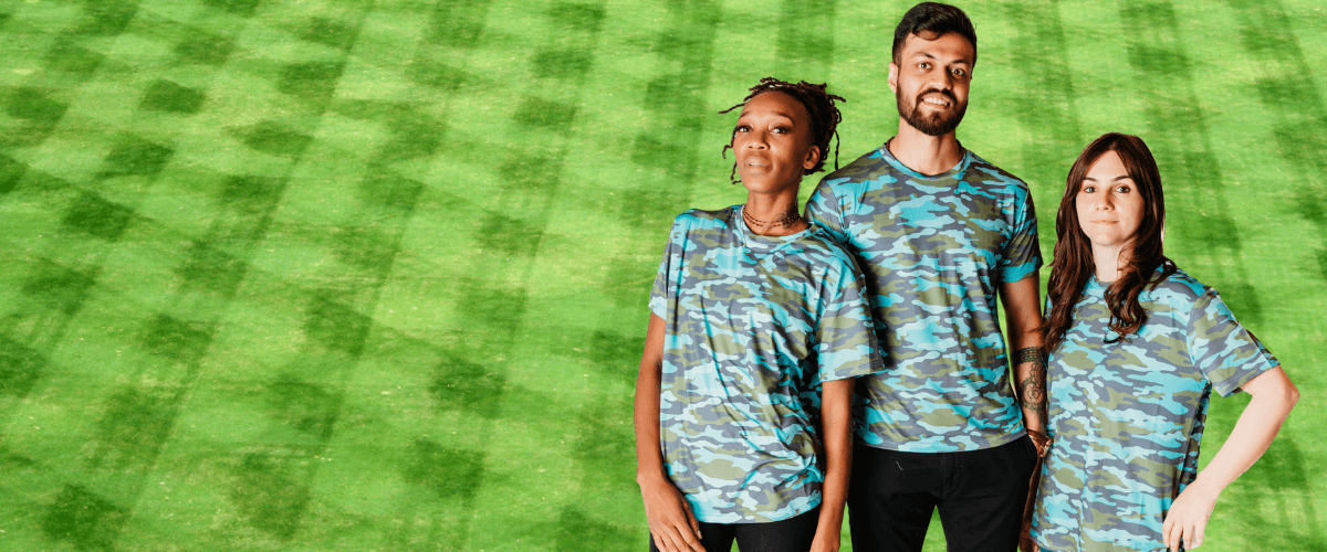 Models posing in custom print performance shirt in front of green backdrop