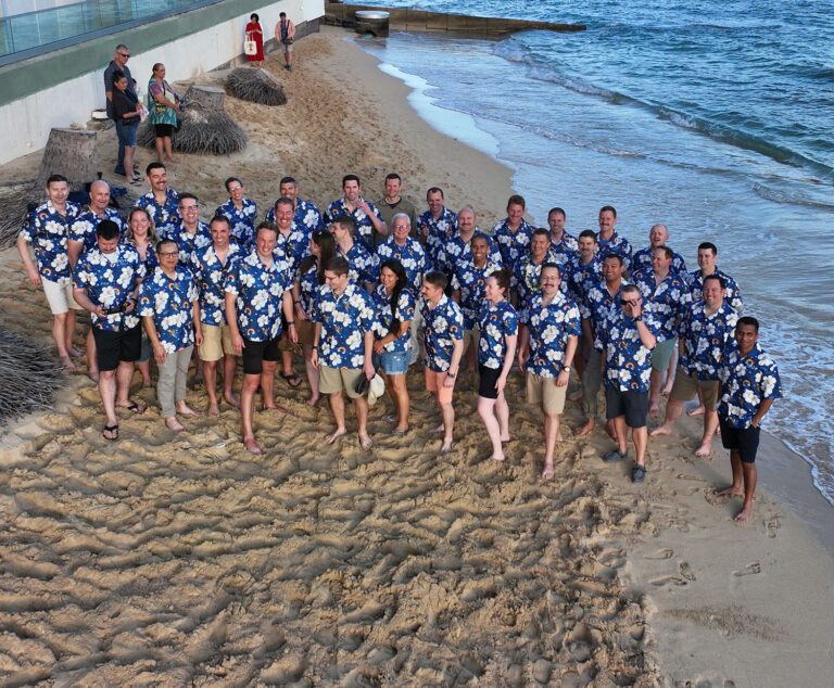 Group photo of SAASS team wearing custom Hawaiian shirts