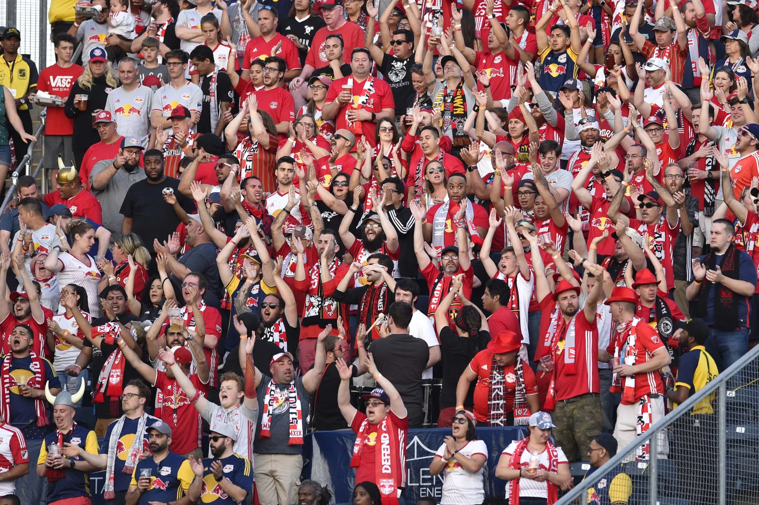 Soccer crowd wearing red jerseys and red knit scarves