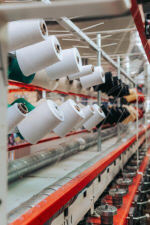 A photo of a large machine with many spools of thread.