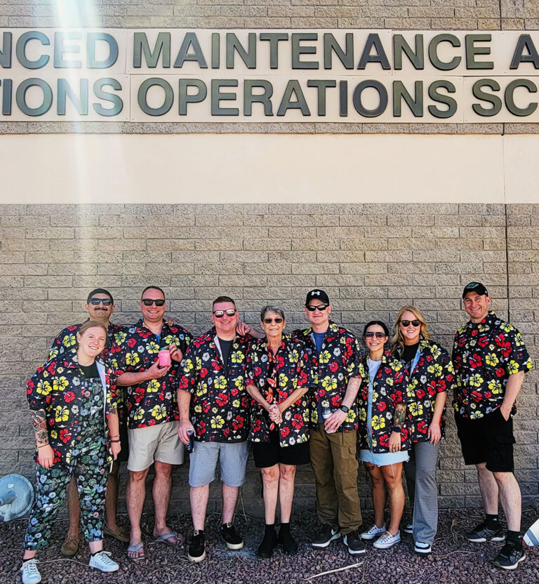 A photo of nine people wearing the USAF AMMOS shirts Candor Threads created.
