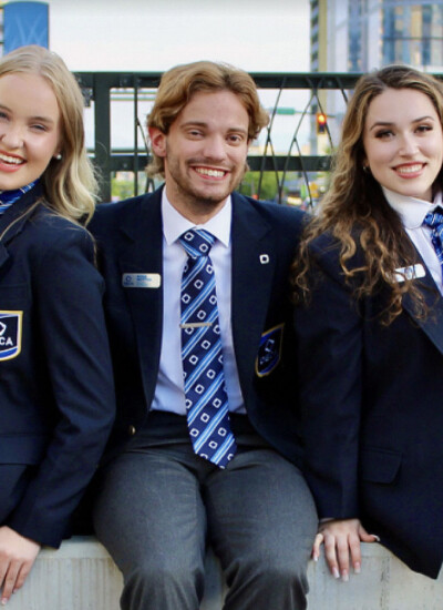 Photo of three people wearing DECA ties and scarves
