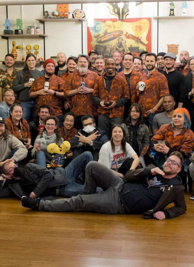 Group photo of Double Fine team wearing their custom Hawaiian shirts