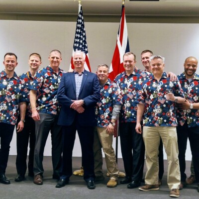 Becky,
I lived in Chicago for about 10 years so happy to share some love back home. Attached is a photo with our Embassy Team wearing one of the shirts we bought from you. Also attached is a news article with me wearing it at a John Paul Jones “Father of the US Navy” birthday event in Scotland.
V/r,
Michael
